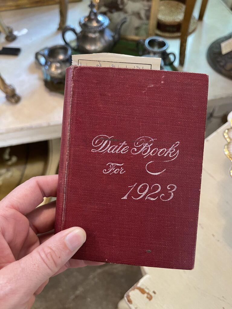 A small, hardcover diary from 1923. The diary is covered in a darker-ish red linen. "Date Book for 1923" is debossed in the center. 