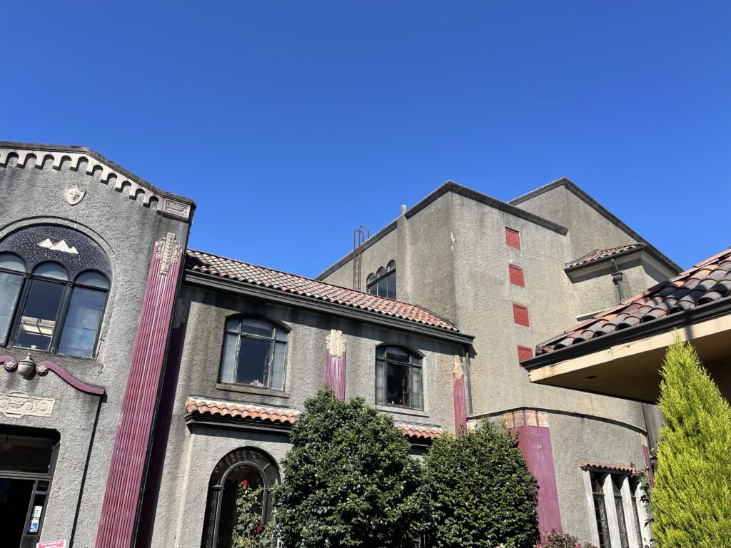 View of a portion of the exterior of Wilhelm's, looking up toward the very clear and blue sky. 