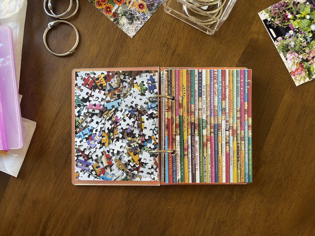 Spread #1. The left-hand page is a photo of the puzzle's unpuzzled pieces. The right-hand page is a photo of the completed puzzle of a bunch of colorful pencils. 