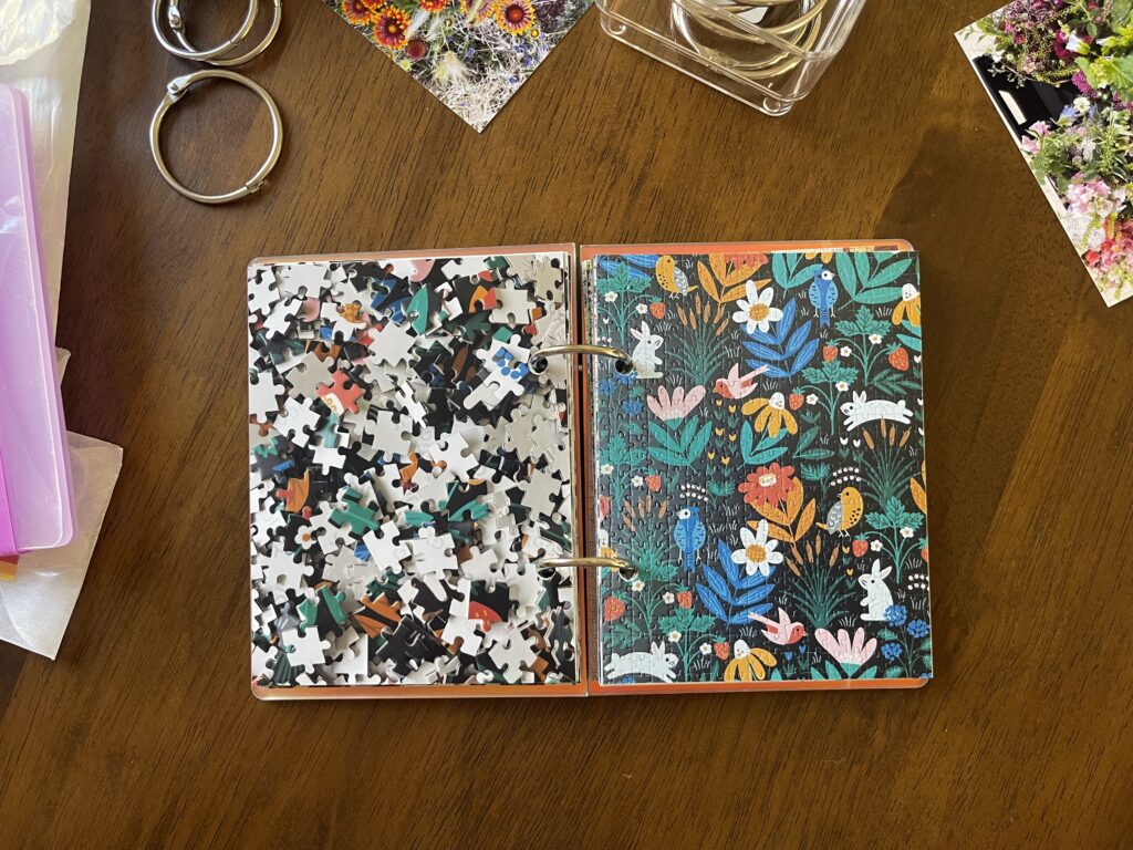 Spread #10. The left-hand page is a photo of the puzzle's unpuzzled pieces. The right-hand page is a photo of the completed puzzle of stylized illustrations of flowers, birds, and bunnies. 